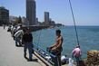Fishing and relaxing along the wide alley making up Beirut's corniche.